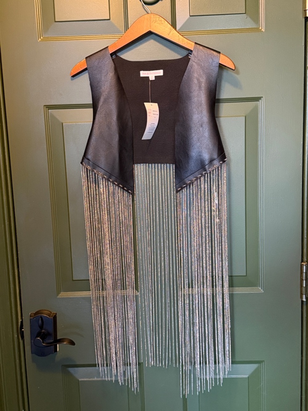 Cute faux leather black vest with chains.